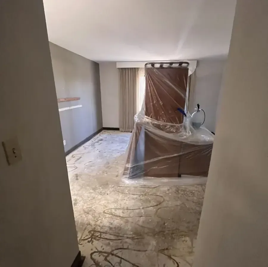 Plastic sheeting protecting furniture inside an unfinished room